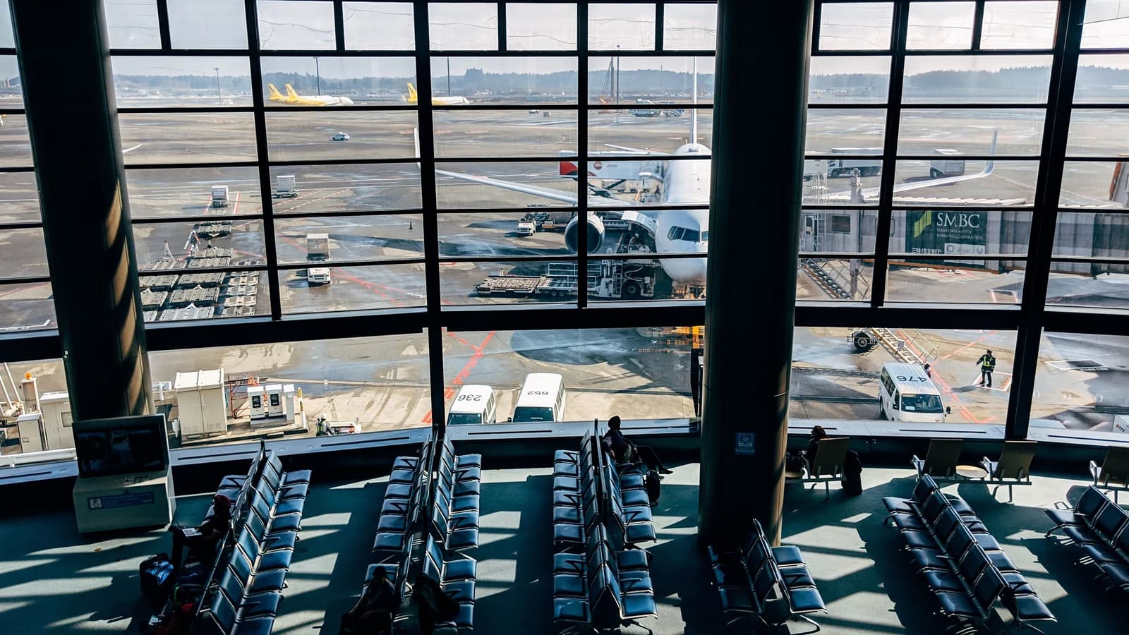 Spacious airport terminal with an airplane and tarmac view in Tokyo, Japan