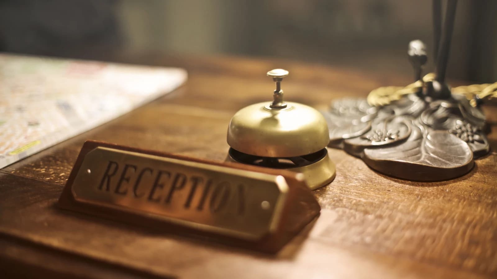 Service bell and reception sign on a hotel counter