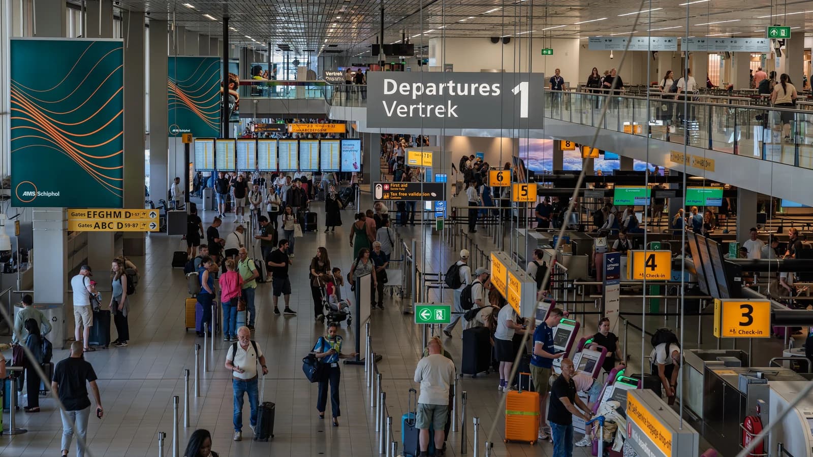Travelers in the departure hall at Amsterdam Schiphol Airport