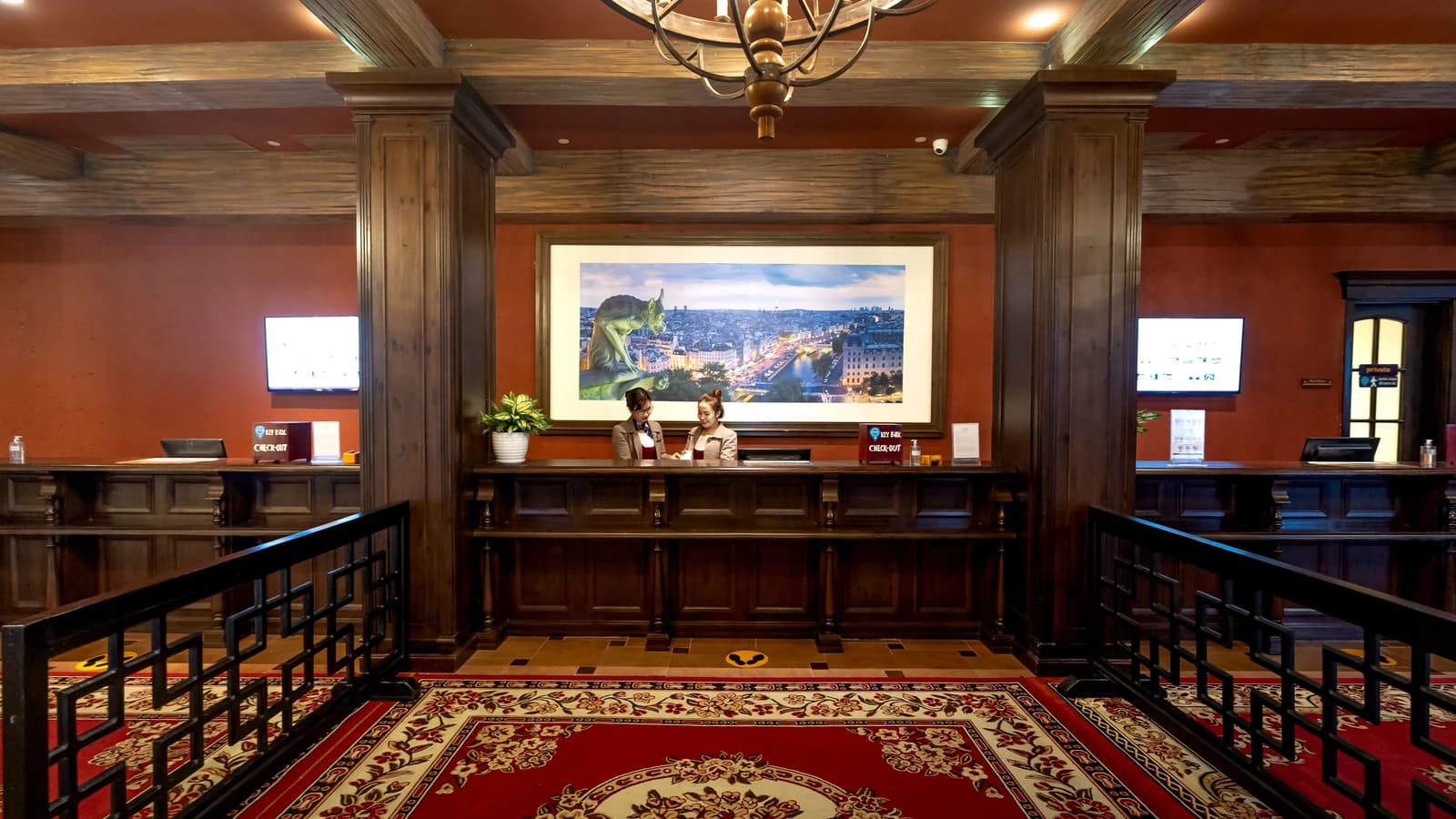 Hotel reception area with wood paneling and a front desk