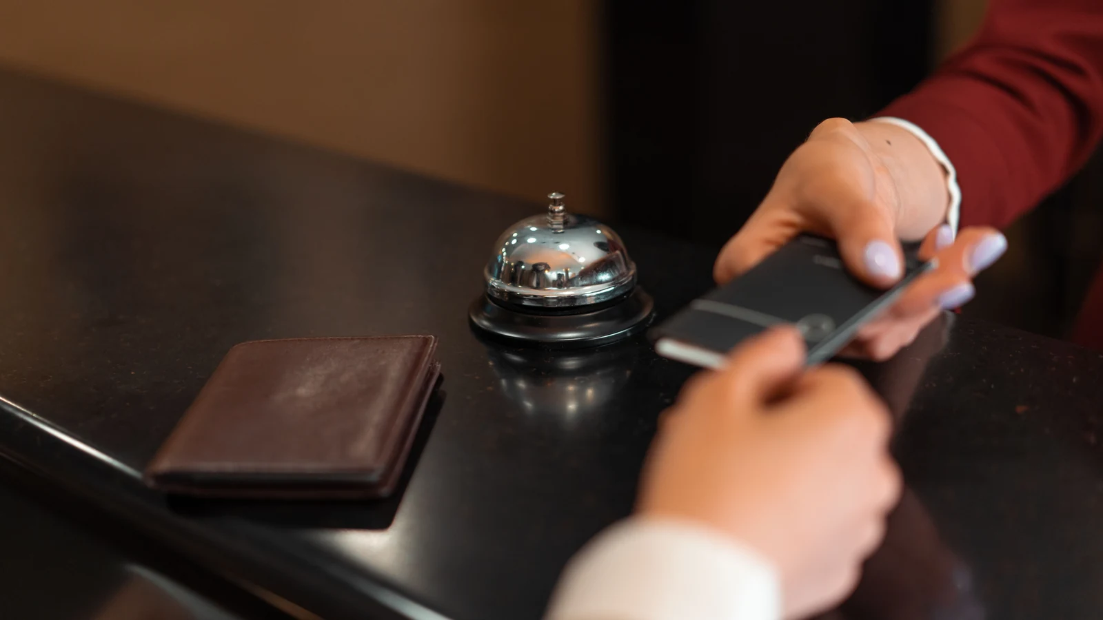 Hotel reception check-in with a smartphone and guest card